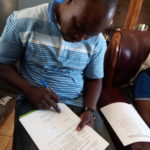 Edward Siwale, the contractor, signs the Certificate of Handover of the Project
