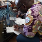Gerald Yambani, Diocesan Treasurer General,  signs the Certificate of Handover of the Project
